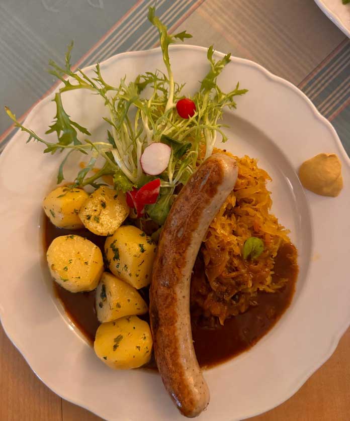 Currywurst with potatoes and sauerkraut.