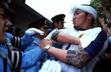 Japanese fans scuffle with police.